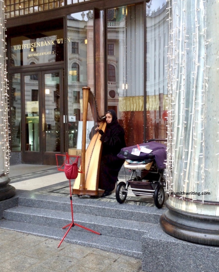 An old woman playing the harp in the streets of Vienna